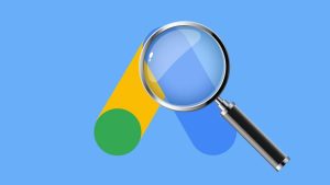 Magnifying glass on top of the Google Ads logo, an audit!